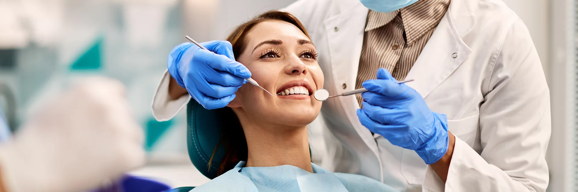Lady smiling getting her teeth checked by dentist