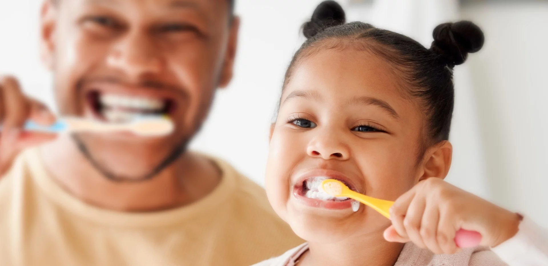 Dad and daughter brushing teeth