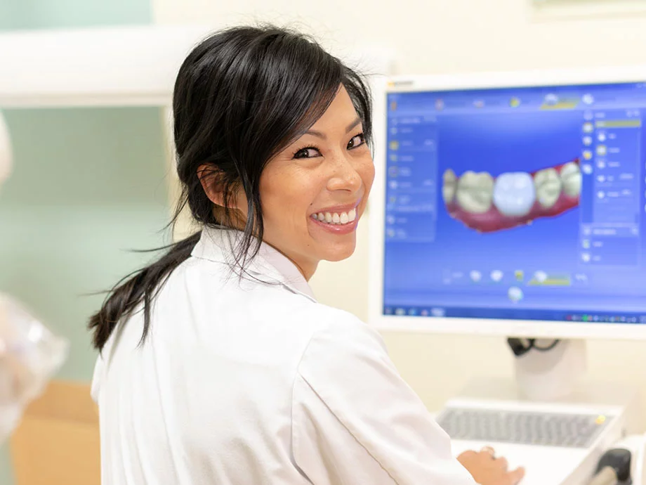Female dentist looking at a computer