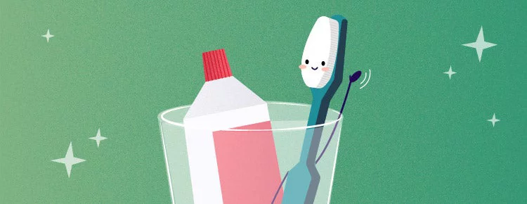 Toothbrush and toothpaste in a glass