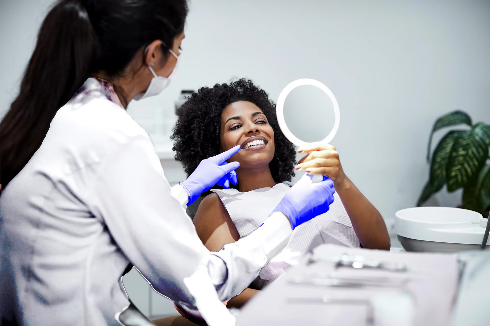 Woman Looking in mirror at dentist