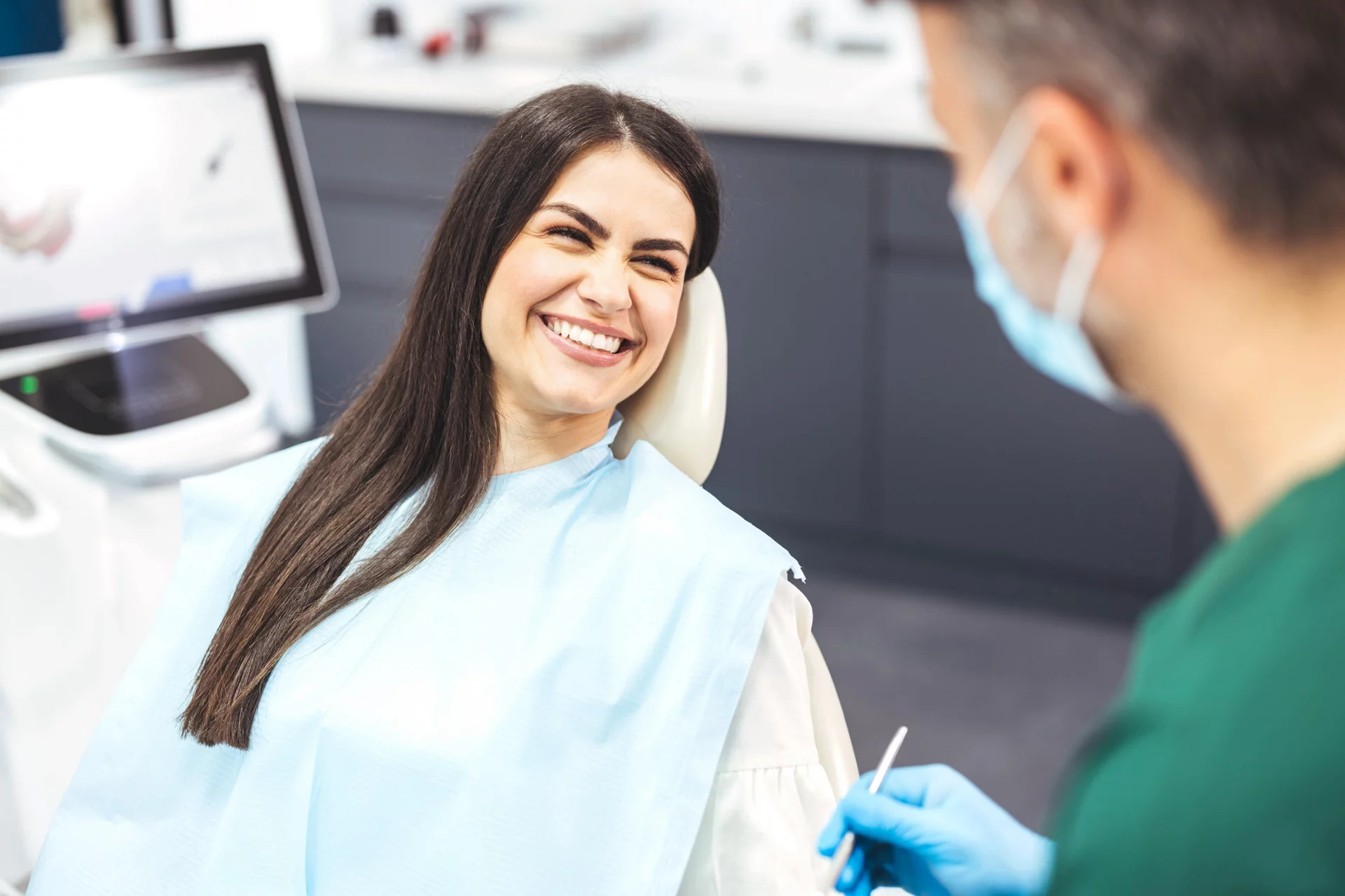 dentist talking with patient regarding scaling and root planing procedure