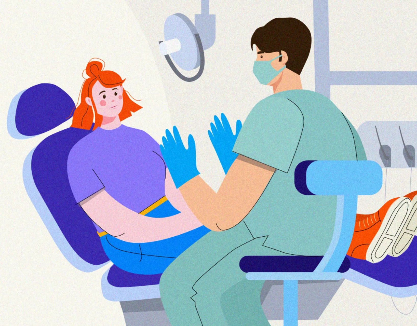 Dentist talking to a patient in the dental chair 