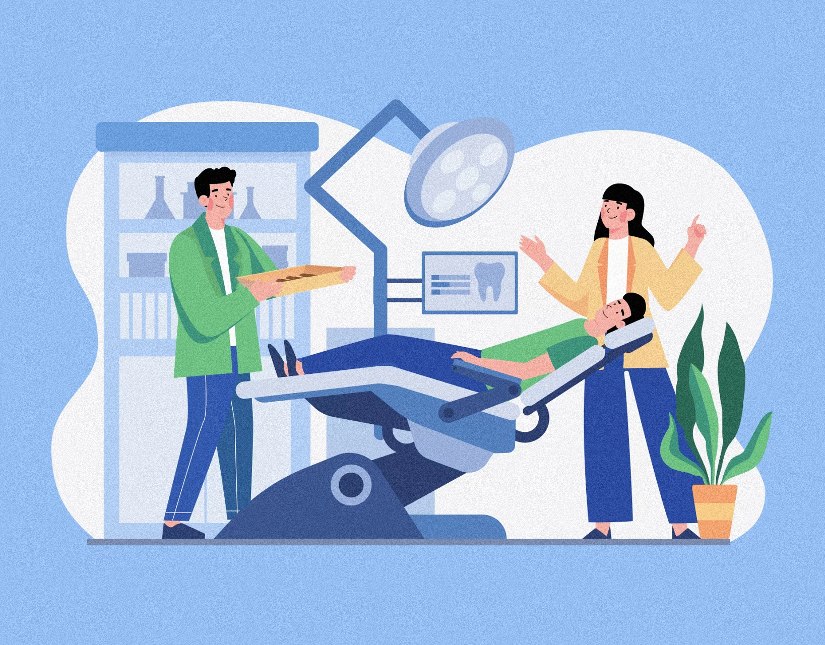 Patient in dental chair with two people