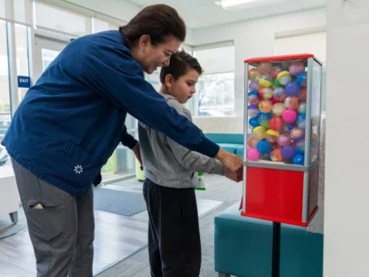 Julian collecting a toy from a toy machine