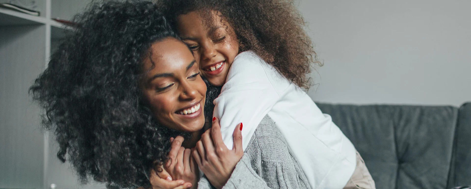 Daughter hugging mother photo