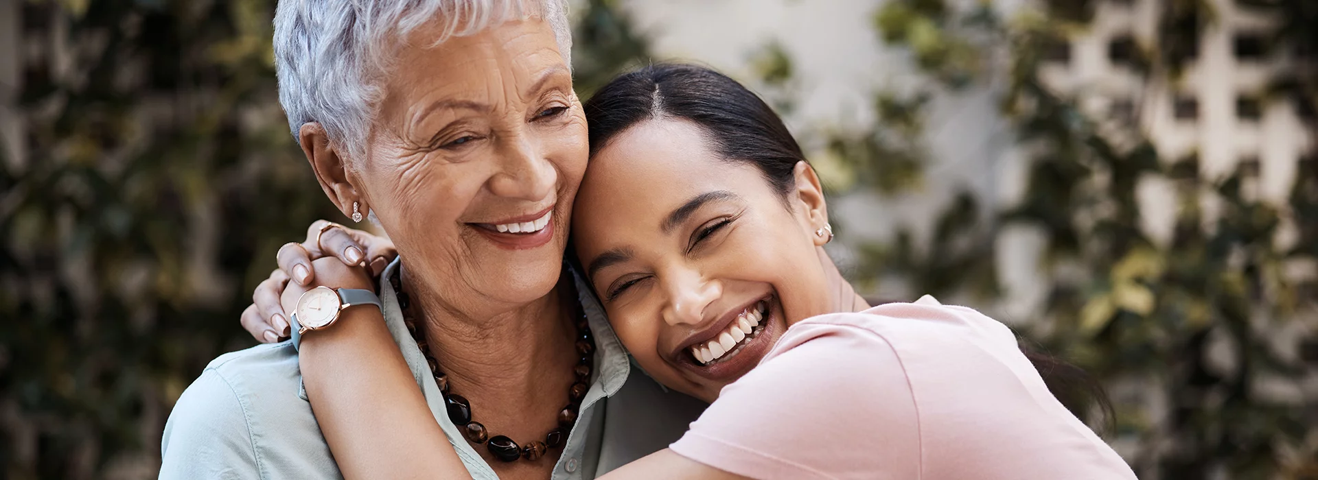 Two women hugging and laughing