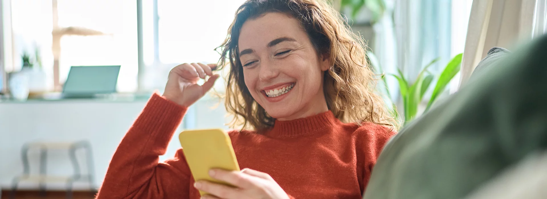 Woman looking at phone with smile