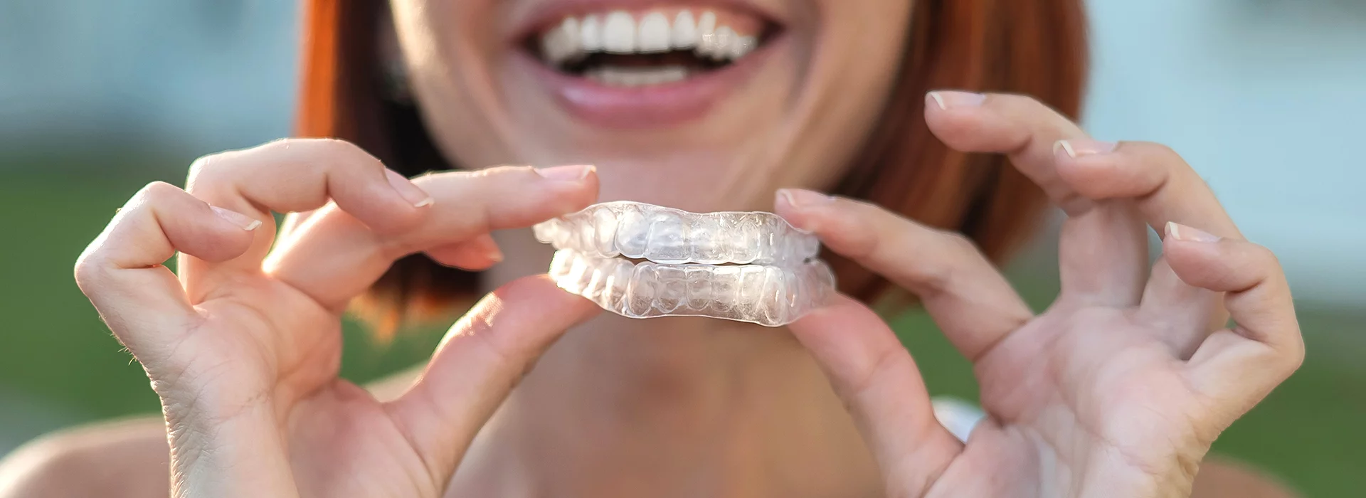 Teen holding Clear Aligner