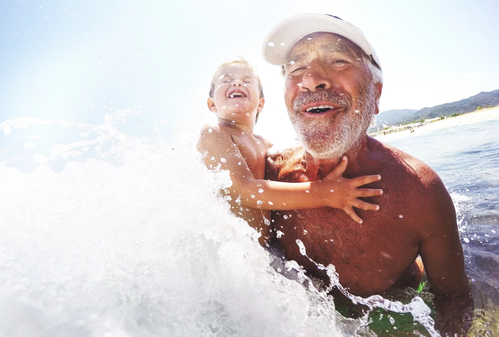 Man with child in ocean