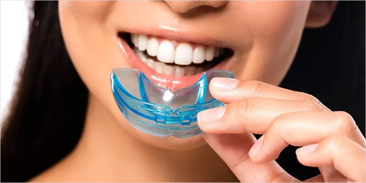Woman putting on a mouth guard