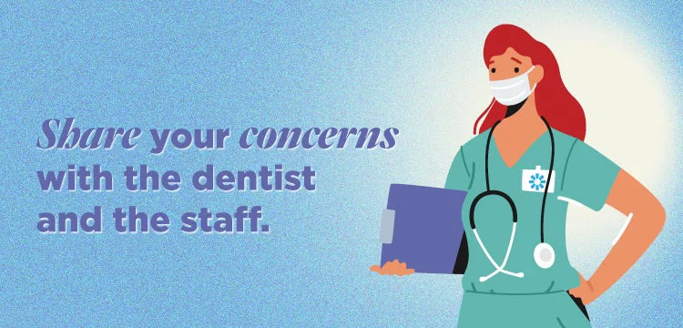 Female dentist in scrubs wearing mask