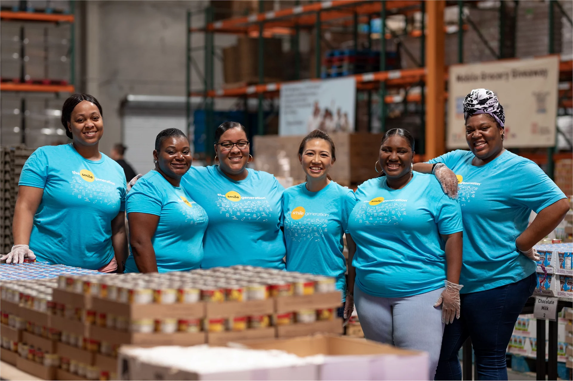 Smile Generation volunteers packing food in a food bank