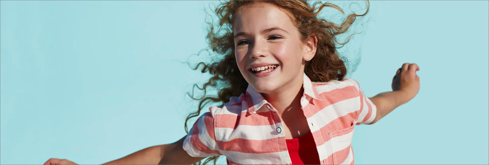 Smiling girl on light blue background