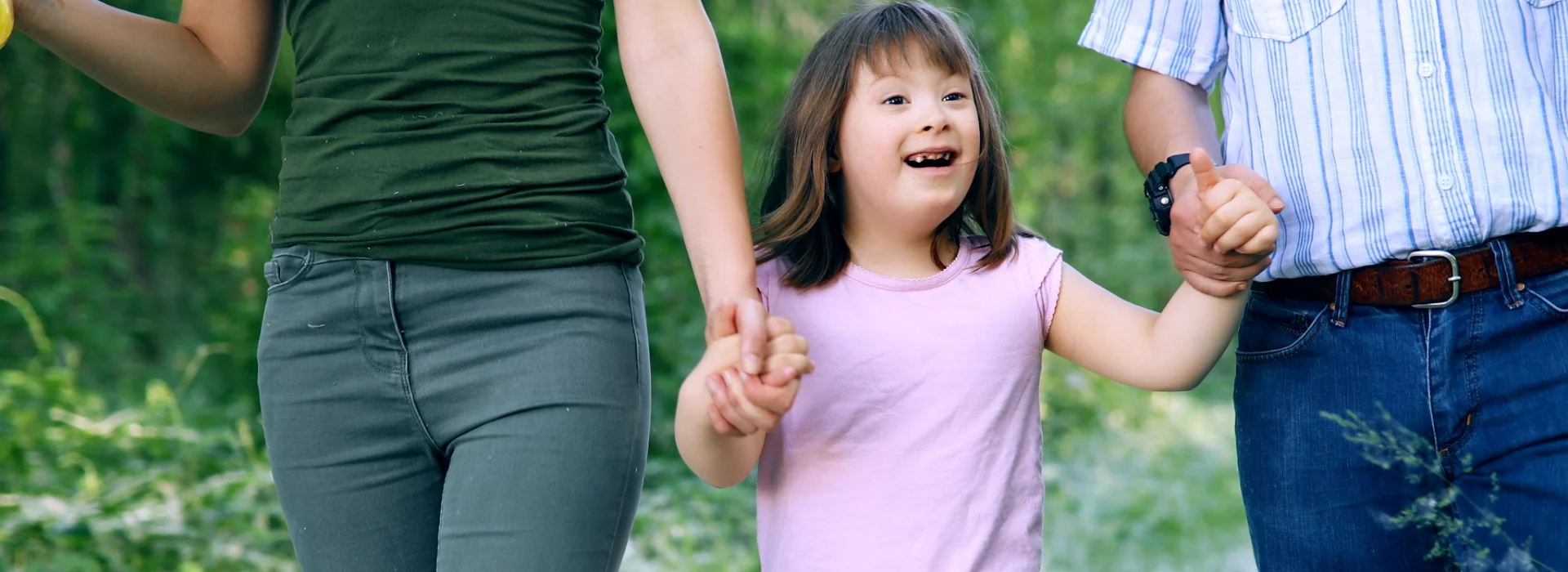 Two parents walking with their child