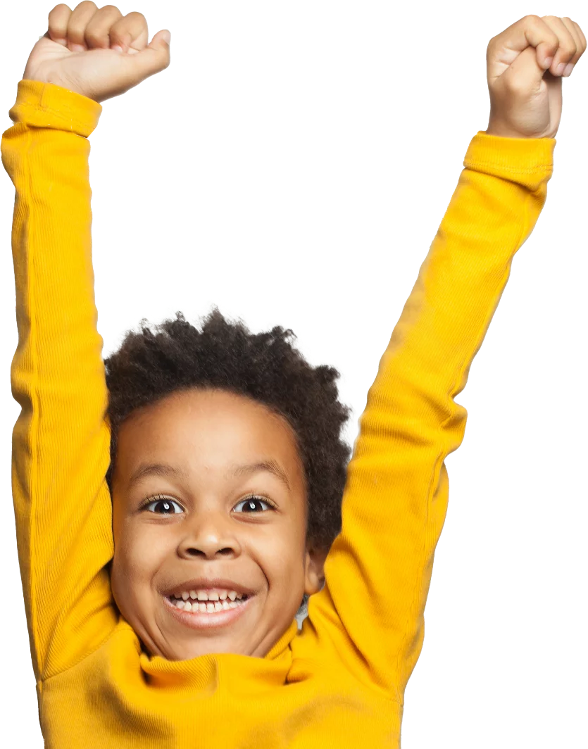 Image of a young boy wearing a yellow sweater is celebrating with arms up