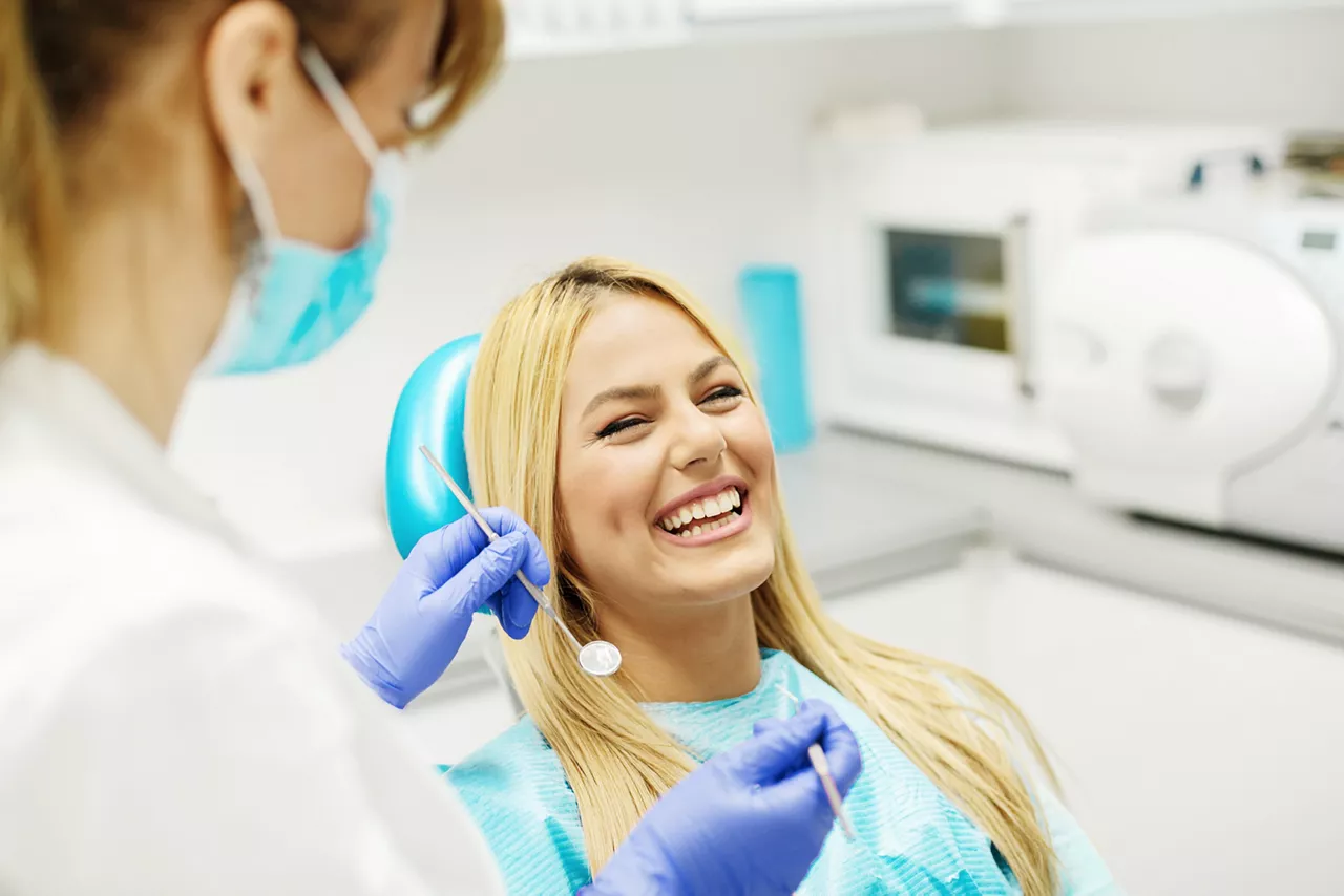 Female dentist working on female client's teeth