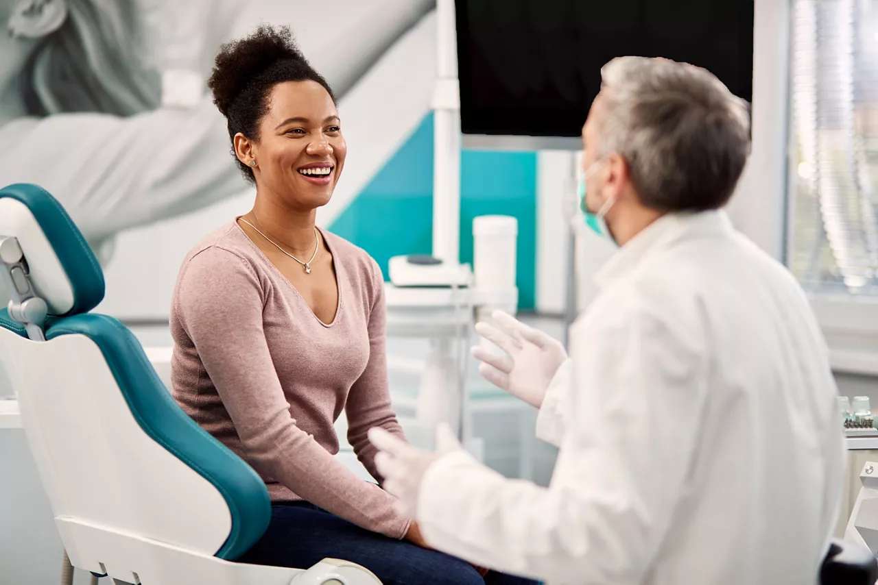 a dental patient speaking with her dentist about her oral health