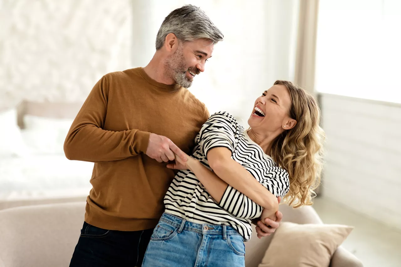 Joyful Couple Dancing And Laughing Having Fun At Home