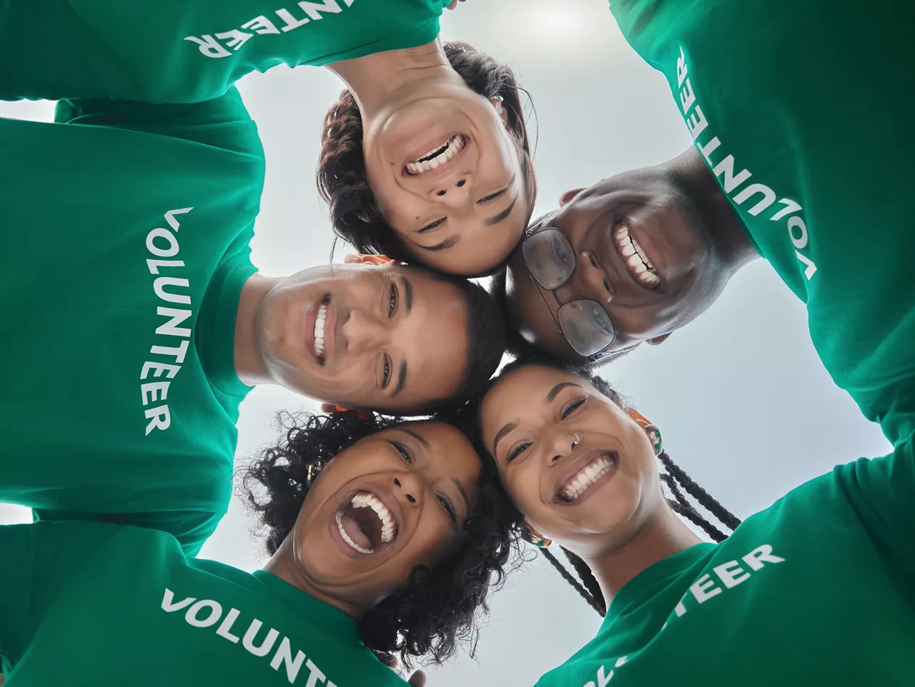 Teamwork, support and volunteer with people on beach for sustainability, environment and climate change. Community, earth day and diversity with friends in circle for charity, energy and recycling
