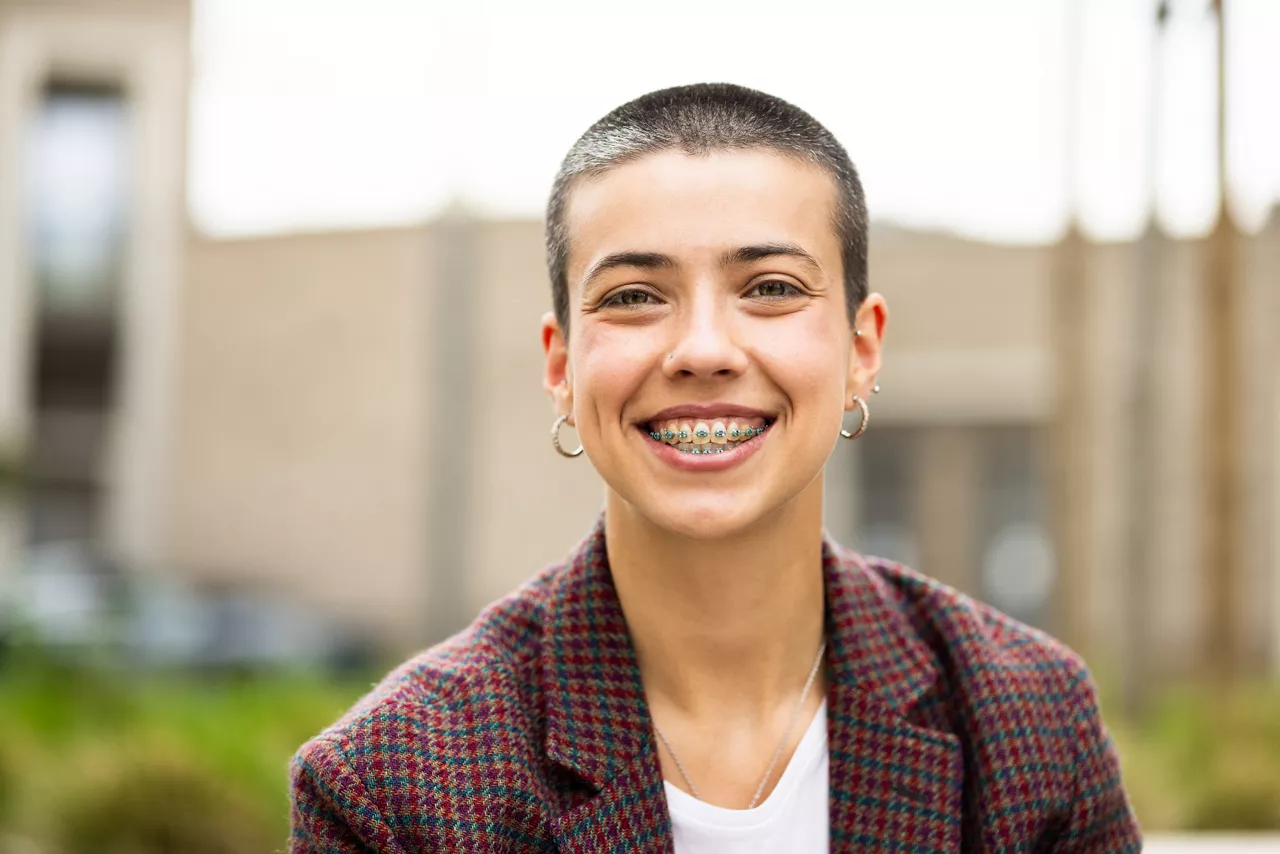 Portrait of a beautiful, young, short-haired businesswoman taking a break outdoors and enjoying.