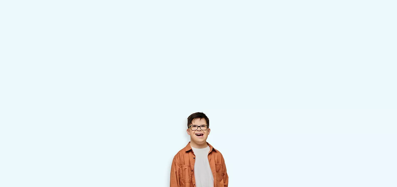 young boy with glasses smiling 
