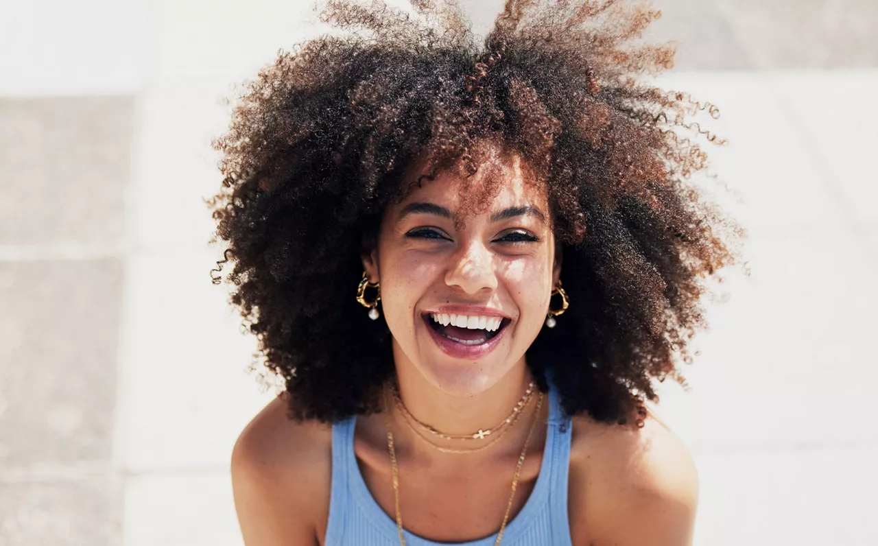 Black woman, happy in portrait with fashion and beauty outdoor, street style with natural hair, makeup and jewelry. Freedom, happiness and mockup with afro, person in Cape Town with mindset and glow.