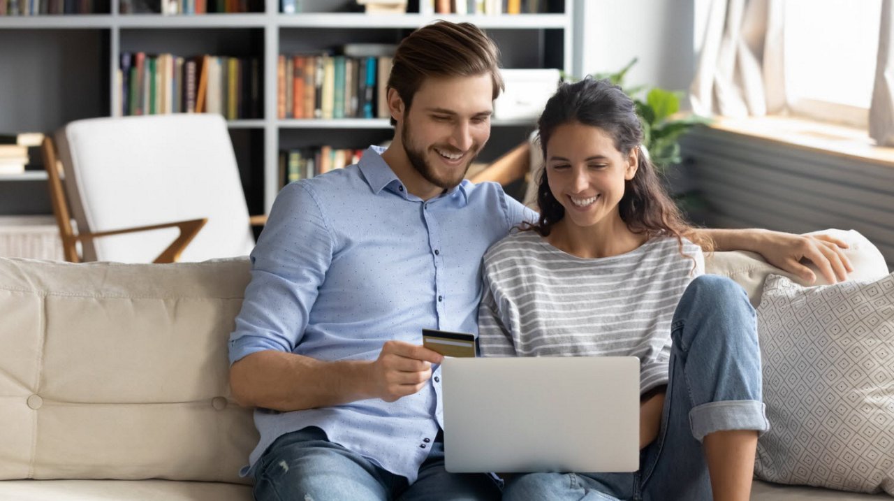Couple focusing on laptop
