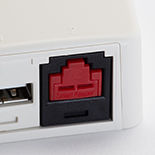 Copper jack installed in a surface mount box, with a red block-out device installed