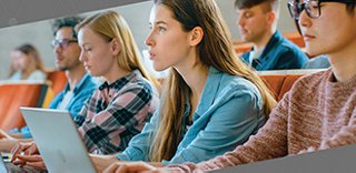 Students in classroom using laptop computers