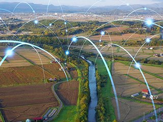 rural landscape with points of light that appear to bounce across the landscape, representing data signals