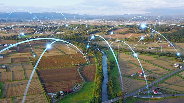 rural landscape with points of light that appear to bounce across the landscape, representing data signals