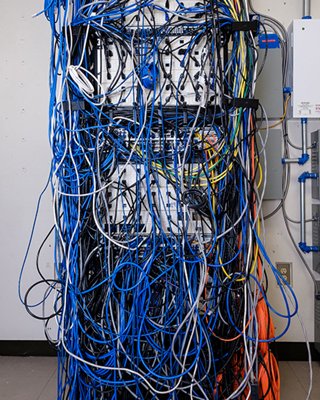 Figure 1: Previous network setup at Capilano University, illustrating disorganized cabling that made troubleshooting and maintenance challenging and time-consuming