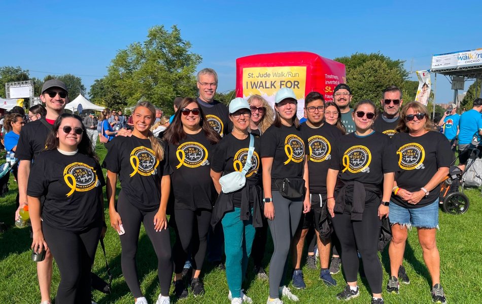 Group of men and women in front of community support race finish line