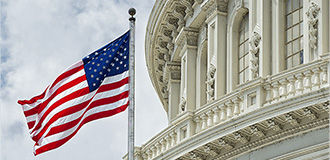 The United States Capitol building with the American flag flying atop its flagpole, Washington DC 