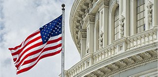 exterior view of a federal government building with a US flag