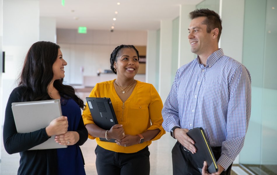 Diverse group of women and men smiling and conversing