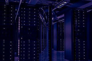 Deep royal blue image of data center cabinets with PDUs