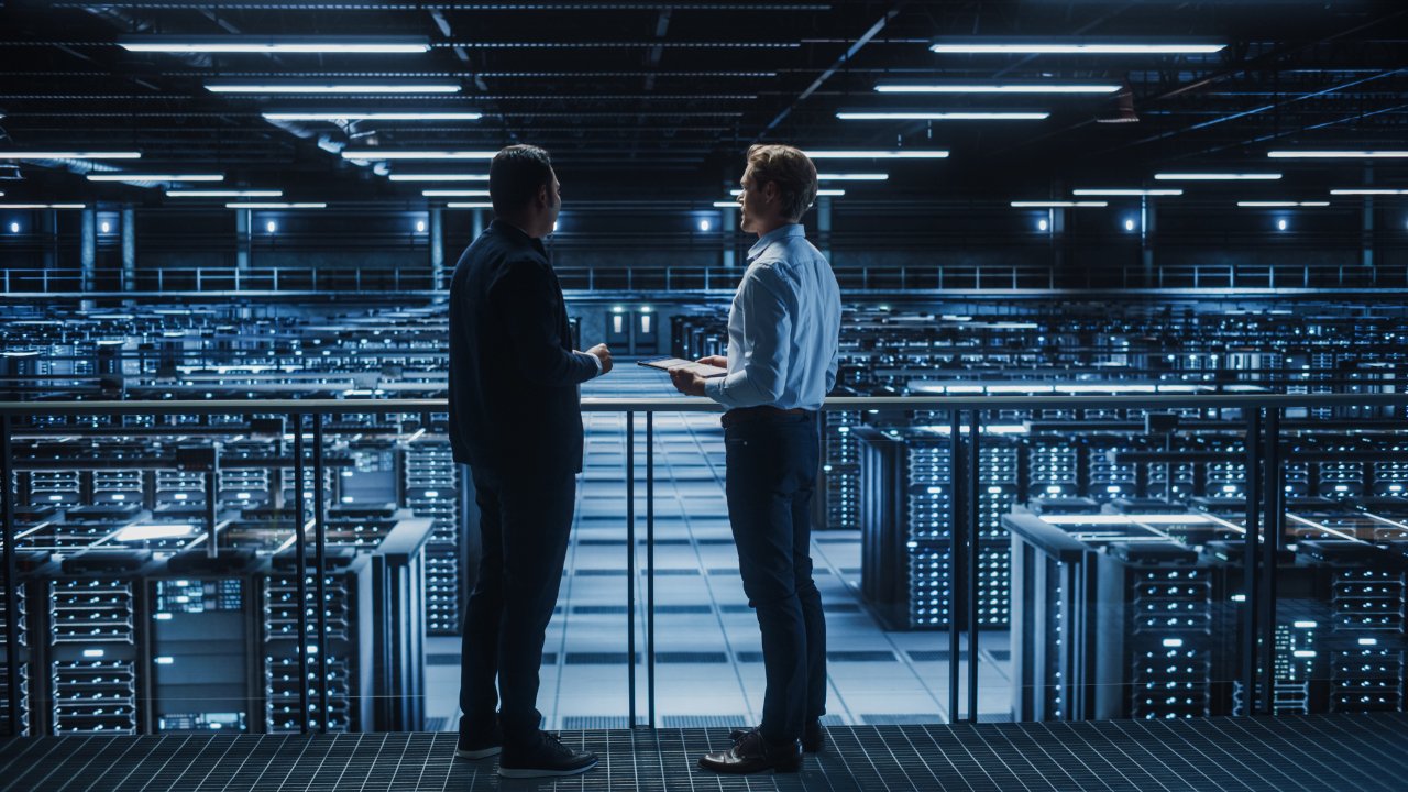 A Data Center Operator and a Data Center Manager overlook a Data Center