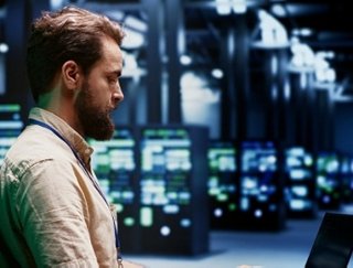 Data Center Operator on his laptop, reviewing his data center environment metrics