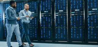 Two Data Center Managers walking through an AI-driven data center