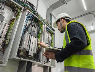 Electrical Engineer working on front of control panel