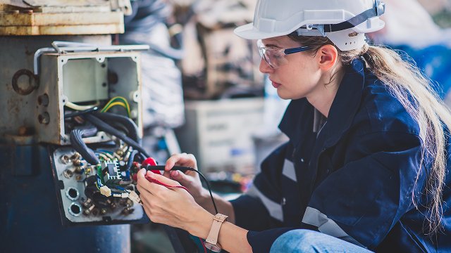 Electrical engineer working in control room for industrial production
