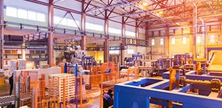 Large warehouse space with steel beams and industrial storage systems