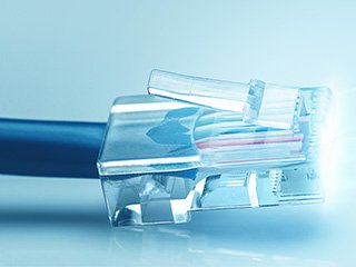 An RJ45 copper connector against a light blue background