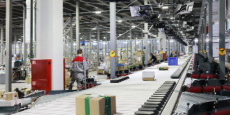 Packages moving down a conveyor belt in an industrial warehouse