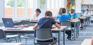students work at classroom tables