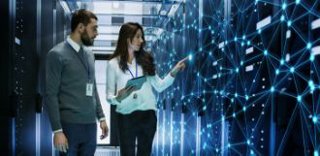 Two people walking through a Data Center checking out connections