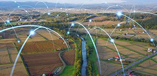 Rural landscape with points of light that appear to bounce across the landscape, representing data signals