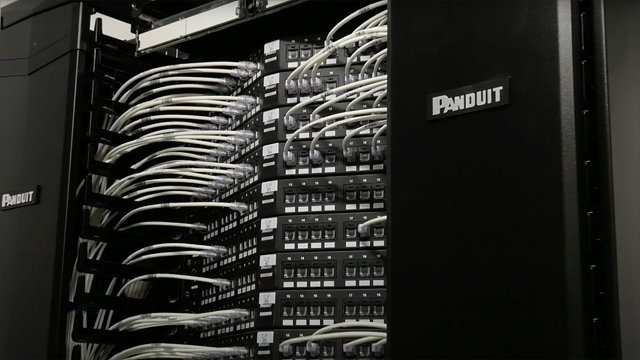 a Panduit rack with cable managers, patch panels and patch cords in a telecommunications room at Intesa Sanpaolo 